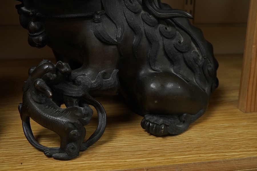 A pair of large 19th century Chinese bronze lion dogs, 26cm